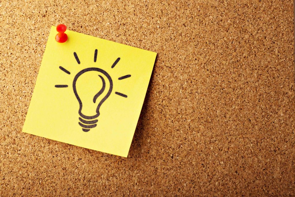 Sticky note with bulb drawing